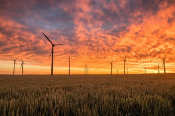 A row of wind turbines in the countryside, representing one of the decarbonisation technologies which could help achieve Net Zero