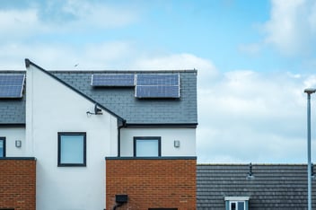 House with solar panels on the roof, representing renewable energy solutions supported by decarbonisation funding